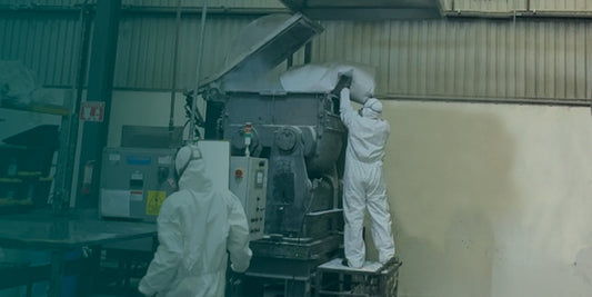 Two colaborators mixing products at industrial production scale