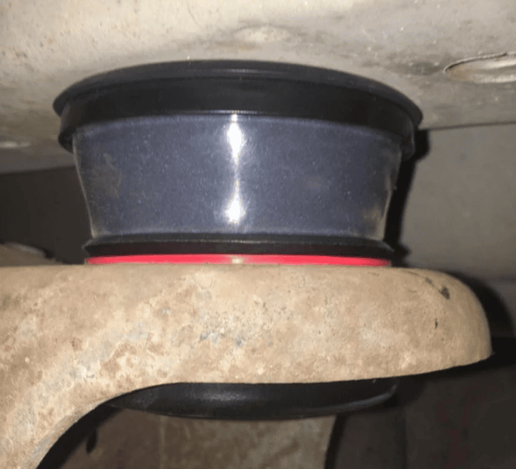 A rubber body mount in a car assembly setting
