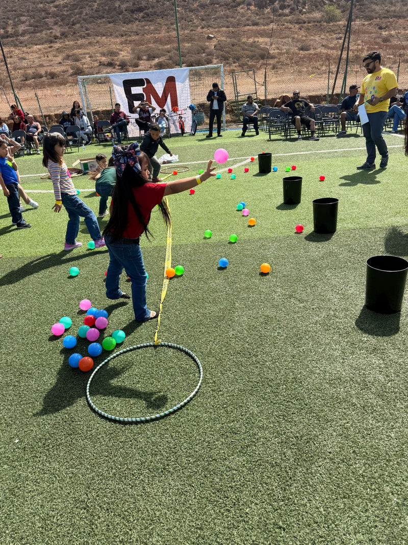 Children playing with colorful balls on a sports field with at Rubber Mexico's Childrens party