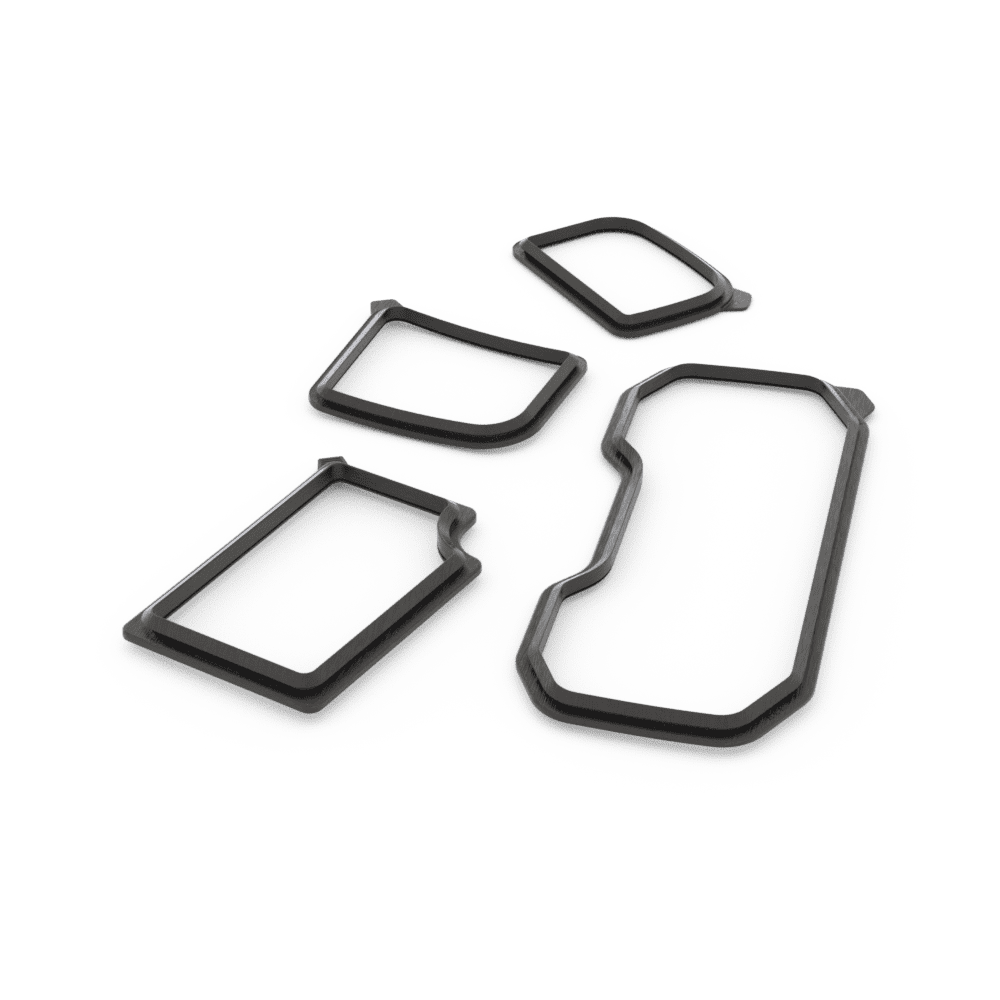 A collection of black window trim seals of various shapes displayed on a white background