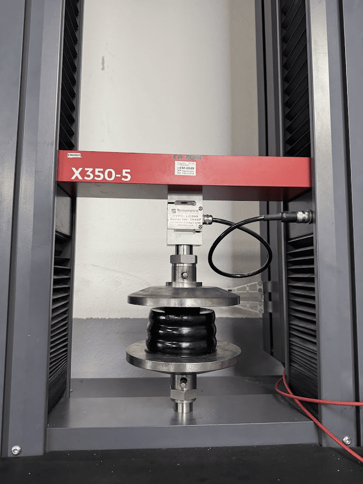 An isolator undergoing a tensile strength test