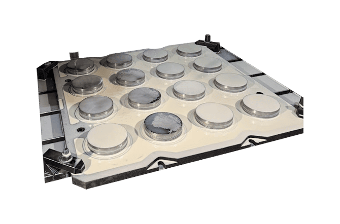 A metal mold with several circles in the center