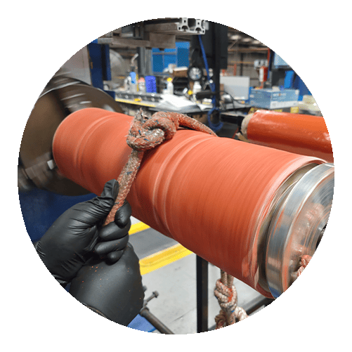 A person molding in a lathe a rubber hose